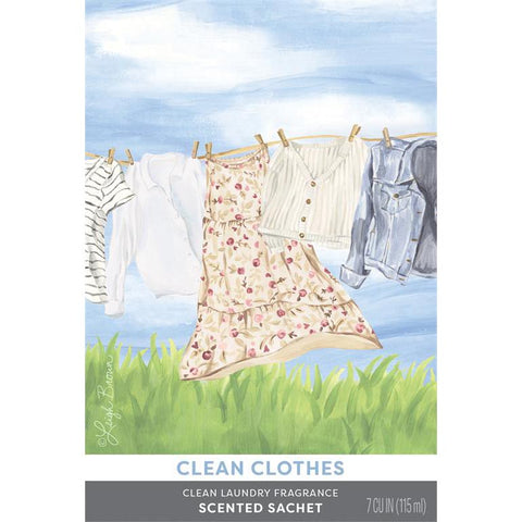 A rectangular scented sachet label for 'Clean Clothes' laundry fragrance by Leigh Anne Burns, featuring a watercolor illustration of hanging clothes on a line against a blue sky and green grass, with product text at the bottom.